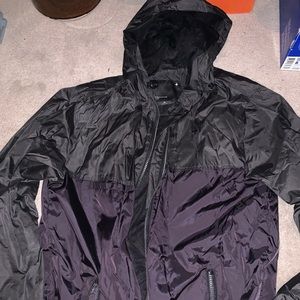 Two tone black/dark grey rain jacket.